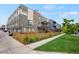 Modern townhome features a mix of brick and siding, a fenced front yard, and a second-story balcony at 1921 Hooker St, Denver, CO 80204