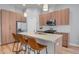Modern kitchen features wood cabinets, a spacious island with seating, and stainless steel appliances, perfect for cooking at 1921 Hooker St, Denver, CO 80204