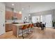 Modern kitchen features wood cabinets, stainless appliances, an island with seating, and an adjacent dining area at 1921 Hooker St, Denver, CO 80204
