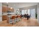 Open-concept kitchen boasts an island with barstool seating and a seamless transition into the dining area at 1921 Hooker St, Denver, CO 80204