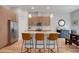 Stylish kitchen with wood cabinets, granite countertops, stainless steel appliances, and a breakfast bar with seating at 1921 Hooker St, Denver, CO 80204