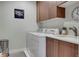 Functional laundry room with washer, dryer, and built-in cabinets at 1921 Hooker St, Denver, CO 80204