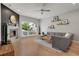 Cozy living room features a corner fireplace, large windows, hardwood floors, and a comfortable sectional sofa at 1921 Hooker St, Denver, CO 80204