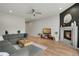 Inviting living room boasts a modern fireplace, sleek hardwood floors, and a spacious gray sectional sofa at 1921 Hooker St, Denver, CO 80204