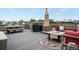 Stylish rooftop deck with a grill, dining table, and comfortable seating around a modern fire pit feature at 1921 Hooker St, Denver, CO 80204