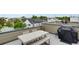 Rooftop dining area with a large table and grill, offering stunning views of the surrounding neighborhood at 1921 Hooker St, Denver, CO 80204