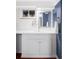 Bathroom featuring white vanity and a uniquely framed mirror and blue accent wall at 2030 Cody St, Lakewood, CO 80215