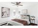 Bright bedroom with large windows, stylish art, and ceiling fan at 2030 Cody St, Lakewood, CO 80215