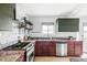 Well-lit kitchen with stainless steel appliances, granite countertops, and mosaic backsplash at 2030 Cody St, Lakewood, CO 80215