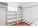 Bright laundry room with built-in shelving and tile flooring, offering ample storage and convenience at 2030 Cody St, Lakewood, CO 80215