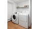 This laundry room features modern appliances with a front load washer and top load dryer at 2030 Cody St, Lakewood, CO 80215