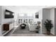 Cozy living room featuring large windows, a sleek sofa, and a modern entertainment center at 2030 Cody St, Lakewood, CO 80215