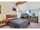 Bright bedroom featuring a cozy bed, a desk area, and unique architectural details like exposed beams at 2885 Springdale Ln, Boulder, CO 80303