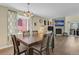 Elegant dining area with a wooden table set for six, seamlessly connected to the living room and fireplace at 2885 Springdale Ln, Boulder, CO 80303