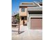 Charming tan and green townhome with a private garage and inviting front entrance at 2885 Springdale Ln, Boulder, CO 80303