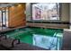 Indoor jacuzzi-style hot tub area with tiled edges and wood paneling, providing a relaxing community amenity at 2885 Springdale Ln, Boulder, CO 80303