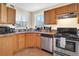 Well-maintained kitchen with stainless steel appliances, wood cabinets, and a view of the outdoors at 2885 Springdale Ln, Boulder, CO 80303
