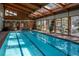 Indoor swimming pool featuring a skylight, wood ceiling, and glass doors, offering year-round enjoyment at 2885 Springdale Ln, Boulder, CO 80303