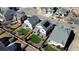 Aerial view of several well-maintained homes showcasing a neighborhood with manicured lawns and community amenities at 17548 E 103Rd Dr, Commerce City, CO 80022