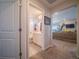 Bathroom featuring a shower and tub combination next to the living room with a neutral brown couch at 17548 E 103Rd Dr, Commerce City, CO 80022