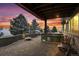 A backyard patio boasts an outdoor kitchen, fire pit, and seating under a covered deck at 7603 Yule Ct, Arvada, CO 80007