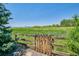 Wooden fence and gate overlooking a grassy field and distant mountains at 7603 Yule Ct, Arvada, CO 80007