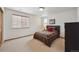 Comfortable bedroom features a patterned comforter, side tables, and a bright window at 7603 Yule Ct, Arvada, CO 80007