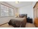 Comfortable bedroom with a queen-sized bed, a window, and a closet at 7603 Yule Ct, Arvada, CO 80007