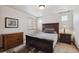 Comfortable bedroom featuring a wood bed and dresser, side tables, and a bright window at 7603 Yule Ct, Arvada, CO 80007