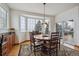 Cozy dining area with a round table, six chairs, and a bay window at 7603 Yule Ct, Arvada, CO 80007