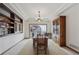 Elegant dining room with coffered ceilings, large windows, and custom cabinetry at 7603 Yule Ct, Arvada, CO 80007