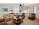 Inviting living room with leather furniture, a fireplace, and view to the kitchen at 7603 Yule Ct, Arvada, CO 80007