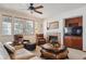 Cozy living room featuring leather furniture, a fireplace, and a ceiling fan at 7603 Yule Ct, Arvada, CO 80007