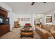 Bright living room with a fireplace, lots of seating and a view to the foyer at 7603 Yule Ct, Arvada, CO 80007