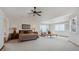 Large main bedroom featuring vaulted ceilings, plush carpet, ample natural light, and a ceiling fan at 7603 Yule Ct, Arvada, CO 80007