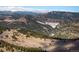 Expansive aerial view of rolling hills, dense forests, and a serene mountain landscape at 636 Chute Rd, Golden, CO 80403