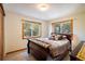 Bright bedroom with carpet, a sleigh bed and views from the wooden trimmed windows at 636 Chute Rd, Golden, CO 80403