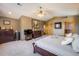 Spacious primary bedroom featuring neutral walls and trim, light colored carpet and an ornate wooden door at 636 Chute Rd, Golden, CO 80403