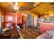 Open dining area with hardwood floors, stone accent wall, and access to the kitchen at 636 Chute Rd, Golden, CO 80403