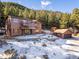 Beautiful multi-story home with a large garage, shed, balcony, and views of the surrounding pine forest at 636 Chute Rd, Golden, CO 80403