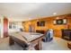 Entertainment room with a fireplace, a pool table and wood paneled wall at 636 Chute Rd, Golden, CO 80403