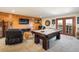 Spacious game room featuring a pool table and cozy seating area with wood accents at 636 Chute Rd, Golden, CO 80403