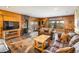 Cozy living room features wood paneling, fireplace, and lovely views at 636 Chute Rd, Golden, CO 80403