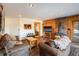 Cozy living room with wood burning fireplace, exposed wood walls, and hardwood flooring at 636 Chute Rd, Golden, CO 80403