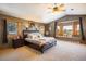 Spacious main bedroom with a scenic window seat, ceiling fan, and large bed at 636 Chute Rd, Golden, CO 80403