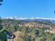Breathtaking view of snow-capped mountains and lush green forests under a clear blue sky at 636 Chute Rd, Golden, CO 80403
