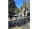 Scenic river view showcasing clear water flowing over smooth rocks surrounded by trees at 636 Chute Rd, Golden, CO 80403