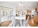 Bright breakfast nook features a white round table with seating for four, wood floors and access to the outdoor patio at 19377 E Radcliff Pl, Aurora, CO 80015