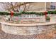 Festive Fairfield Village community entrance with stone wall and holiday garland featuring red bows at 19377 E Radcliff Pl, Aurora, CO 80015