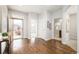 Open concept home entrance with gleaming hardwood floors and neutral paint at 19377 E Radcliff Pl, Aurora, CO 80015